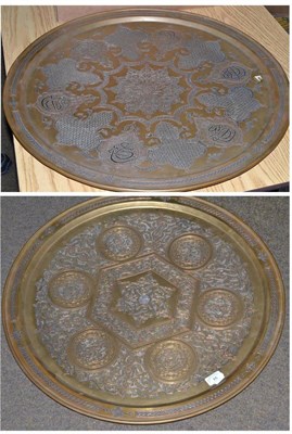 Lot 94 - A Cairo ware brass charger, the reverse signed, 65cm diameter, a similar larger charger, 67cm...