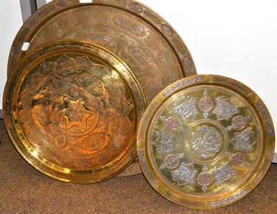 Lot 95 - Three Cairo ware brass chargers, 41cm, 47cm and 60cm diameter (one signed)