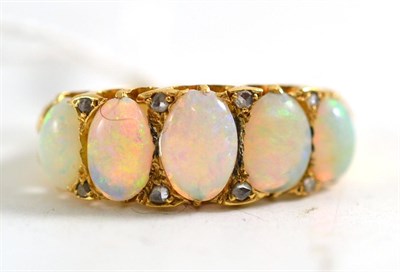 Lot 100 - An opal and diamond ring, five graduated oval cabochon opals with pairs of tiny rose cut...