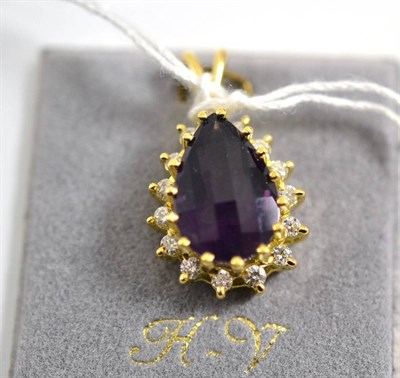 Lot 112 - An 18ct gold amethyst and diamond pendant, a faceted amethyst within a border of brilliant cut...