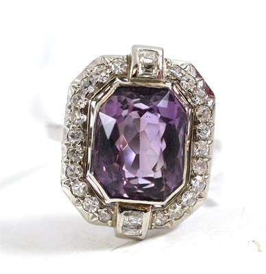 Lot 114 - An amethyst and diamond cluster ring, an octagonal brilliant cut amethyst within a border of...