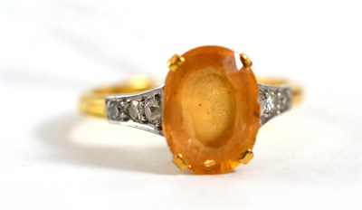 Lot 115 - A topaz and diamond ring, the oval mixed cut topaz in a yellow four claw setting, with three...