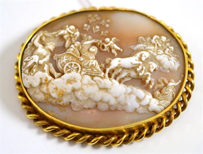 Lot 119 - An oval cameo brooch, carved with a classical scene including a chariot pulled by rearing...