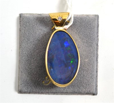 Lot 147 - A 9ct gold opal doublet pendant, an asymmetric opal doublet in a yellow rubbed over setting, with a