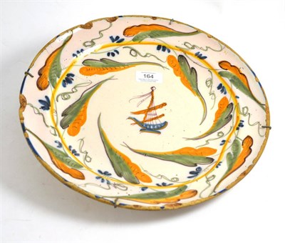 Lot 164 - A Continental Delft polychrome dish, 33cm diameter