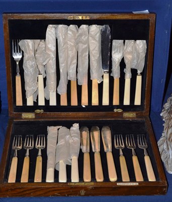 Lot 180 - An oak cased set of fish knives and forks with ivory handles and silver blades and tines, Elkington