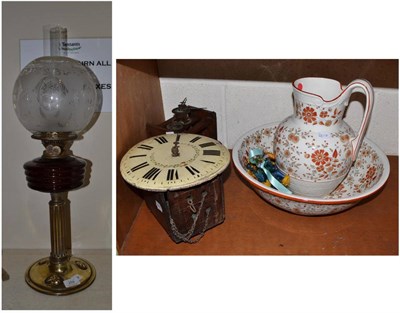 Lot 259 - ~ An Art Nouveau oil lamp, two wall clocks (a.f.), a jug and bowl