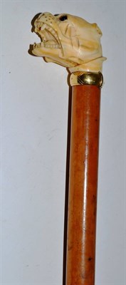 Lot 273 - A Victorian ivory malacca cane with dog head and gold band