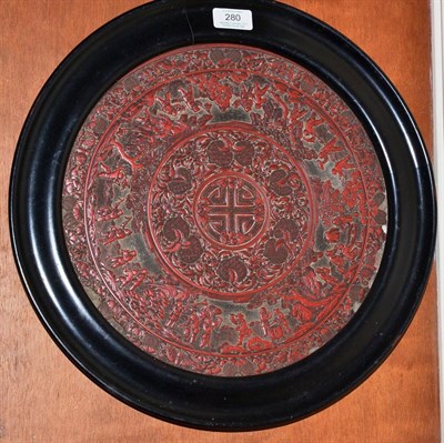 Lot 280 - An 18th/19th century Chinese cinnabar lacquer circular panel (a.f.), 31cm diameter (excluding...