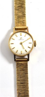 Lot 294 - A lady's 9ct gold wristwatch, signed Omega, 1963, lever movement 19919741, silvered dial with baton