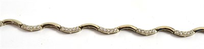 Lot 304 - An 18ct gold diamond bracelet, of wavy form, alternating links set with round brilliant cut...