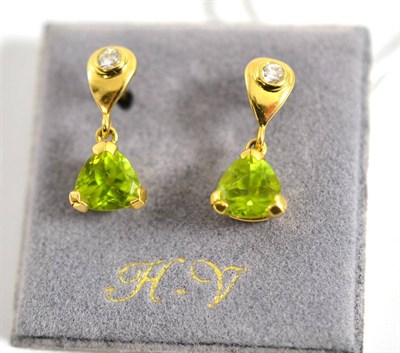 Lot 310 - A pair of 18ct gold peridot and diamond earrings, a drop shape inset with a round brilliant cut...