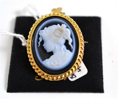 Lot 311 - A 9ct gold cameo brooch/pendant, the onyx carved to depict a maiden with flowers in her hair,...