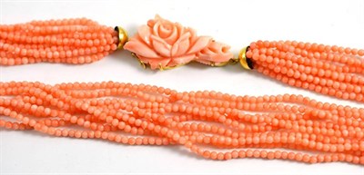 Lot 314 - Coral necklace, multi strand coral beads strung to a carved floral clasp, length 63.5cm