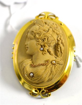 Lot 315 - A lava cameo brooch, with seed pearl and chain decoration in an early 20th century frame,...