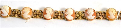 Lot 321 - A cameo bracelet, the oval cameos alternate with floral links, length 19cm