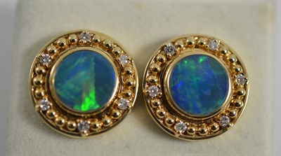 Lot 324 - A pair of opal doublet and diamond earrings, the round opal triplet in a yellow collet setting,...