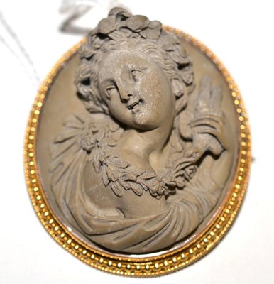 Lot 327 - A lava cameo brooch, the portrait in high relief in a beaded and rope twist decorated frame,...