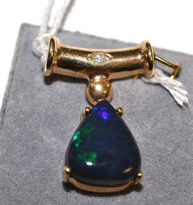 Lot 337 - A 9ct gold opal and diamond pendant, a triangular black opal in a yellow claw setting on a...