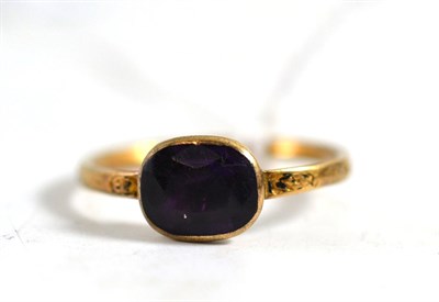 Lot 343 - A Georgian amethyst ring, the amethyst in a yellow collet setting on an engraved shank, the...