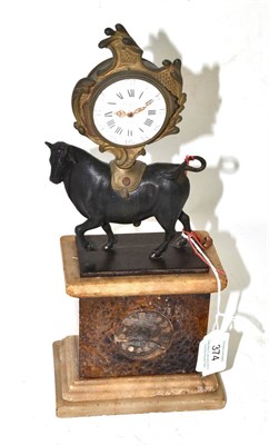 Lot 374 - A mantel timepiece, scroll decorated case supported with a bronzed bull, Blue John base inset...