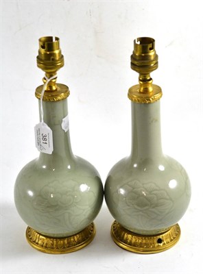 Lot 381 - Pair of Chinese celadon vases mounted as lamps, 28cm high (including fittings)