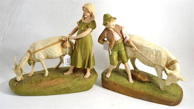 Lot 414 - Pair of Royal Dux figure groups modelled as a boy and girl with goats, 29cm high