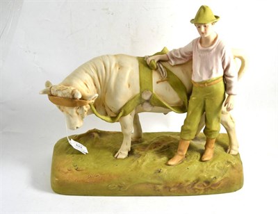 Lot 422 - Royal Dux figure group modelled as a farmer standing beside a bull, 35cm wide (base)