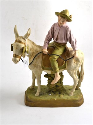 Lot 424 - Royal Dux figure modelled as a boy seated on a donkey, 38cm high