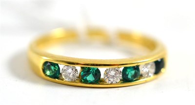 Lot 432 - An 18ct gold emerald and diamond ring, alternating round brilliant cut diamonds and emeralds in...