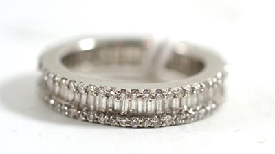 Lot 434 - A diamond eternity ring, the band inset with baguette cut diamonds to the centre and a row of small