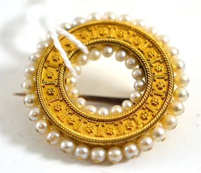 Lot 438 - An archaeological revival brooch, of hoop form, two rows of seed pearls around a beaded and...