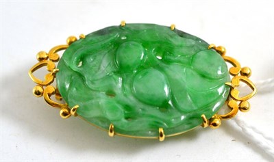 Lot 460 - An 18ct gold jade brooch, carved with fruits and leaves, measures 3.9cm by 2.1cm