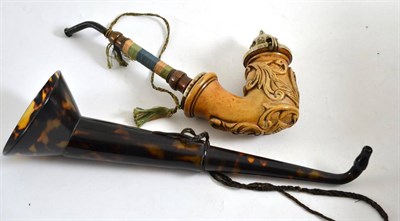 Lot 472 - A plastic faux tortoiseshell hearing aid and a Continental pipe with plated mount