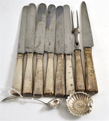 Lot 477 - A set of seven Holy Steel knives, one matching fork, scrolled salt inset with a coin and a spoon