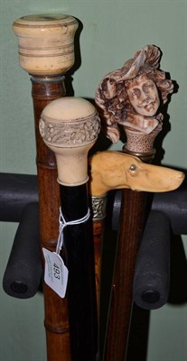 Lot 493 - Walking stick with carved handle in the form of a dogs head, a Victorian example with a handle...