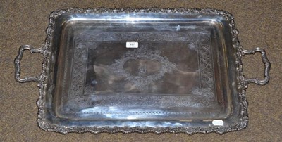 Lot 497 - An engraved silver tray with leaf cast border and scrolled handles, 79cm wide