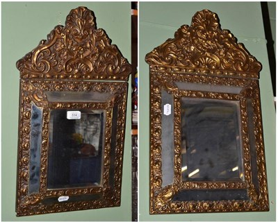 Lot 514 - Pair of repousse brass mirrors, 59cm high