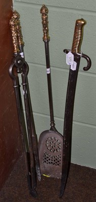 Lot 570 - A set of three Regency brass handled fire irons and a bayonet