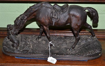 Lot 573 - A possibly Russian bronzed cast iron figure of a horse and dog on a rocky plinth