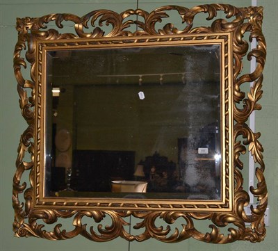 Lot 650 - A giltwood and composition framed wall mirror in the Florentine style