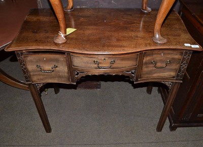 Lot 681 - A Chippendale revival mahogany serpentine shaped serving table with lined fret carving