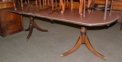 Lot 683 - Regency style mahogany twin-pillar dining table with two additional leaves