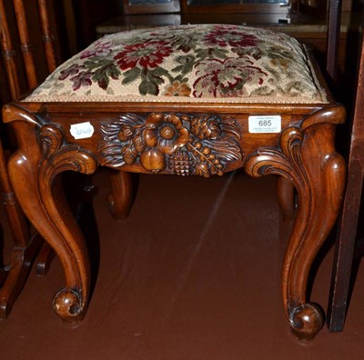 Lot 685 - A Victorian carved mahogany stool raised on cabriole legs with overstuffed seat