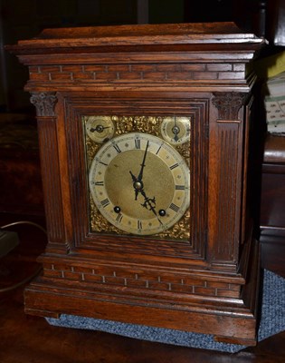 Lot 690 - An oak chiming table clock, circa 1890, glazed side panels, 6-inch dial, two dials for...