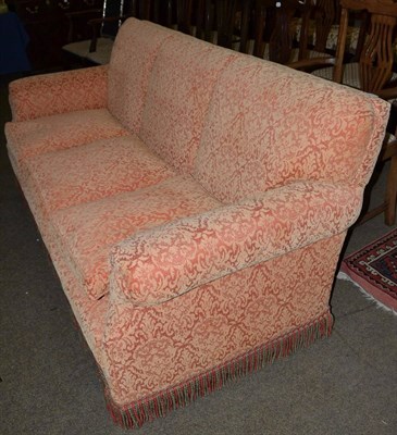 Lot 731 - Three seater feather filled orange patterned sofa