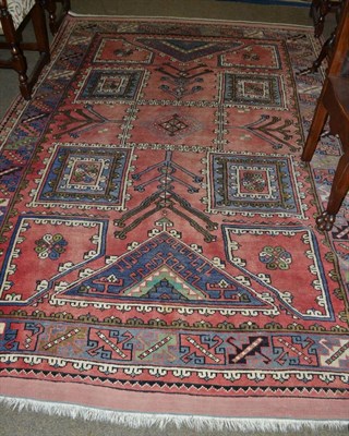 Lot 734 - A Bergama carpet, West Anatolia, the faded rose pink field with five panels framed by spandrels and