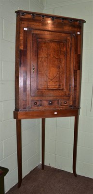 Lot 765 - George III oak and mahogany cross banded corner cupboard on later stand