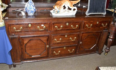 Lot 771 - George III oak and mahogany cross banded dresser base with five drawers and two cupboard doors