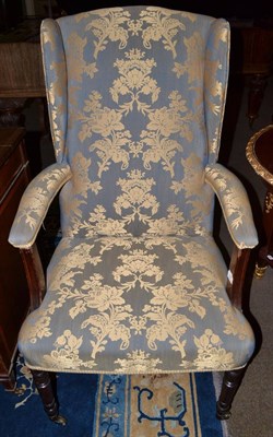 Lot 792 - An early 19th century upholstered mahogany wing armchair on turned forelegs and castors